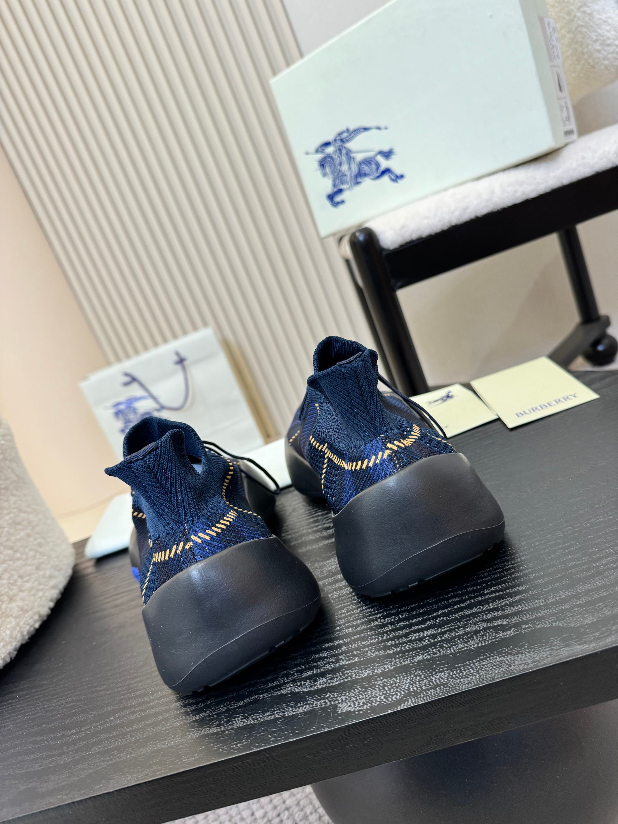 Burberry blue knit slip-on sneakers, heel view, blue sole and yellow stitching