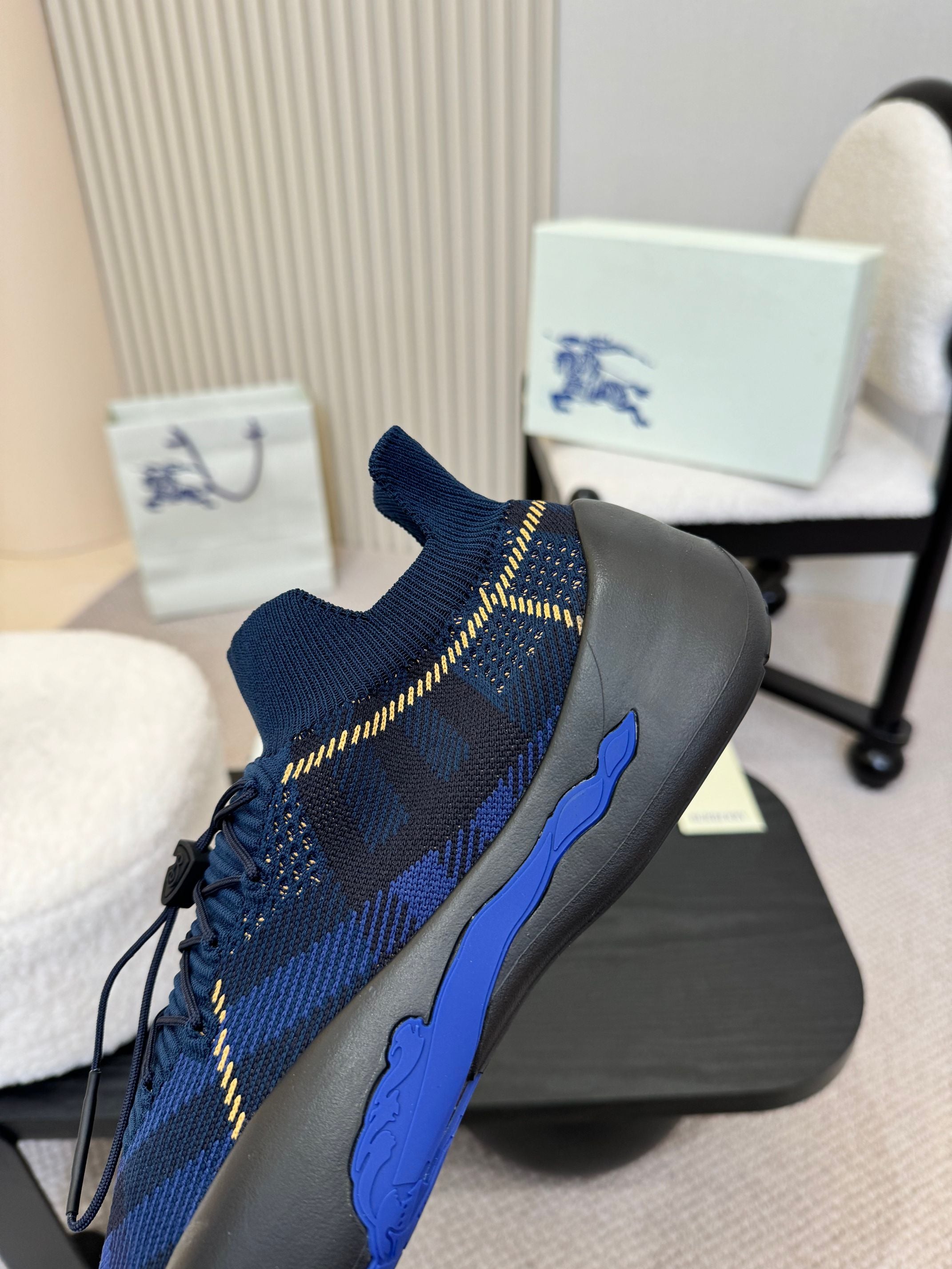 Burberry blue knit slip-on sneaker, front side view, plaid pattern, blue sole