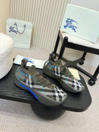 Black and white checkered knit sneaker pair with blue accents and lace-up design