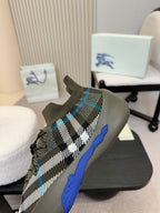 Side view of black and white checkered knit sneaker with blue sole and laces