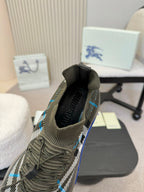 Black and white checkered knit sneaker heel view with blue trim and woven texture