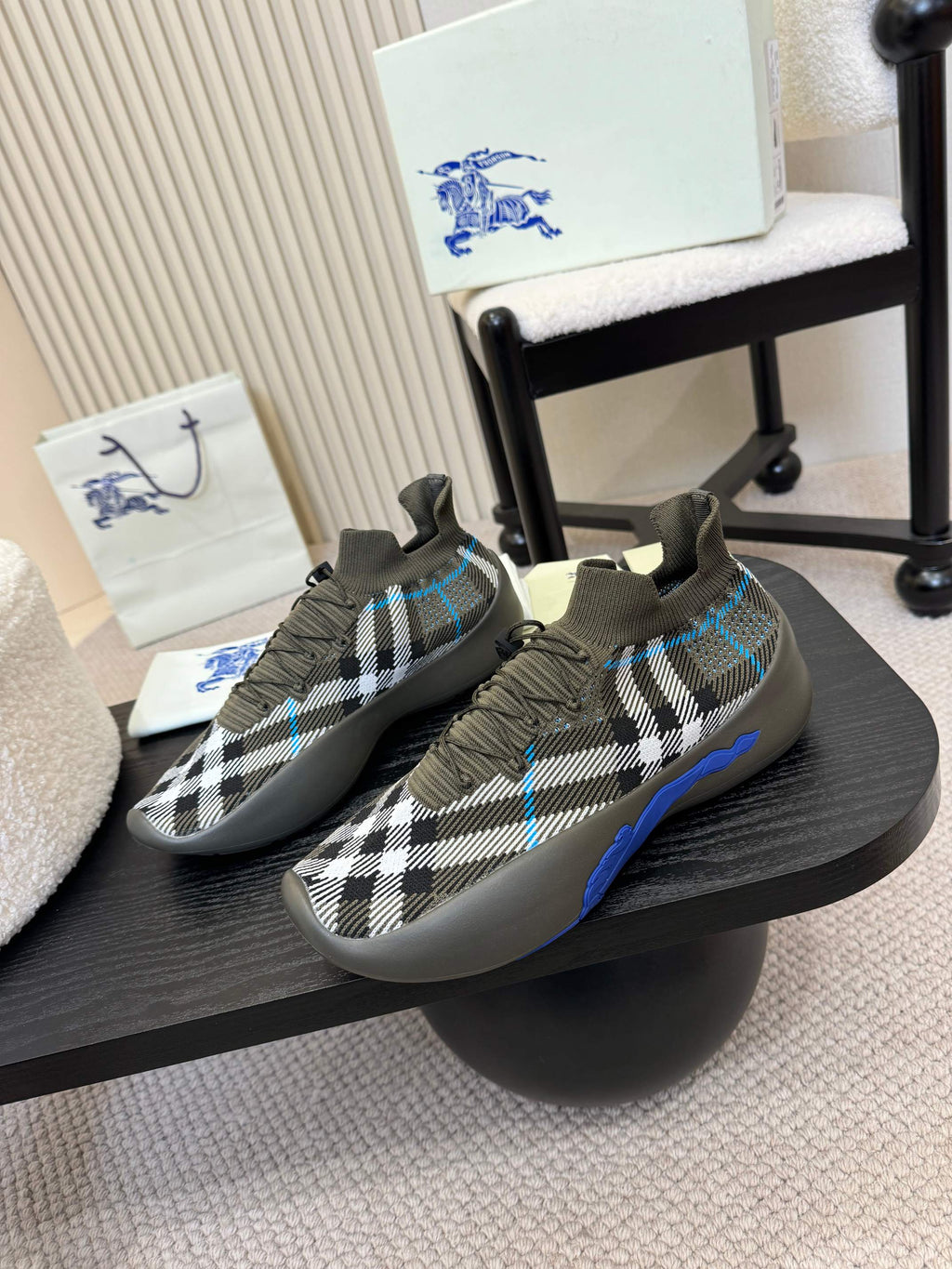 Black and white checkered slip-on sneakers with blue side stripes and cushioned sole