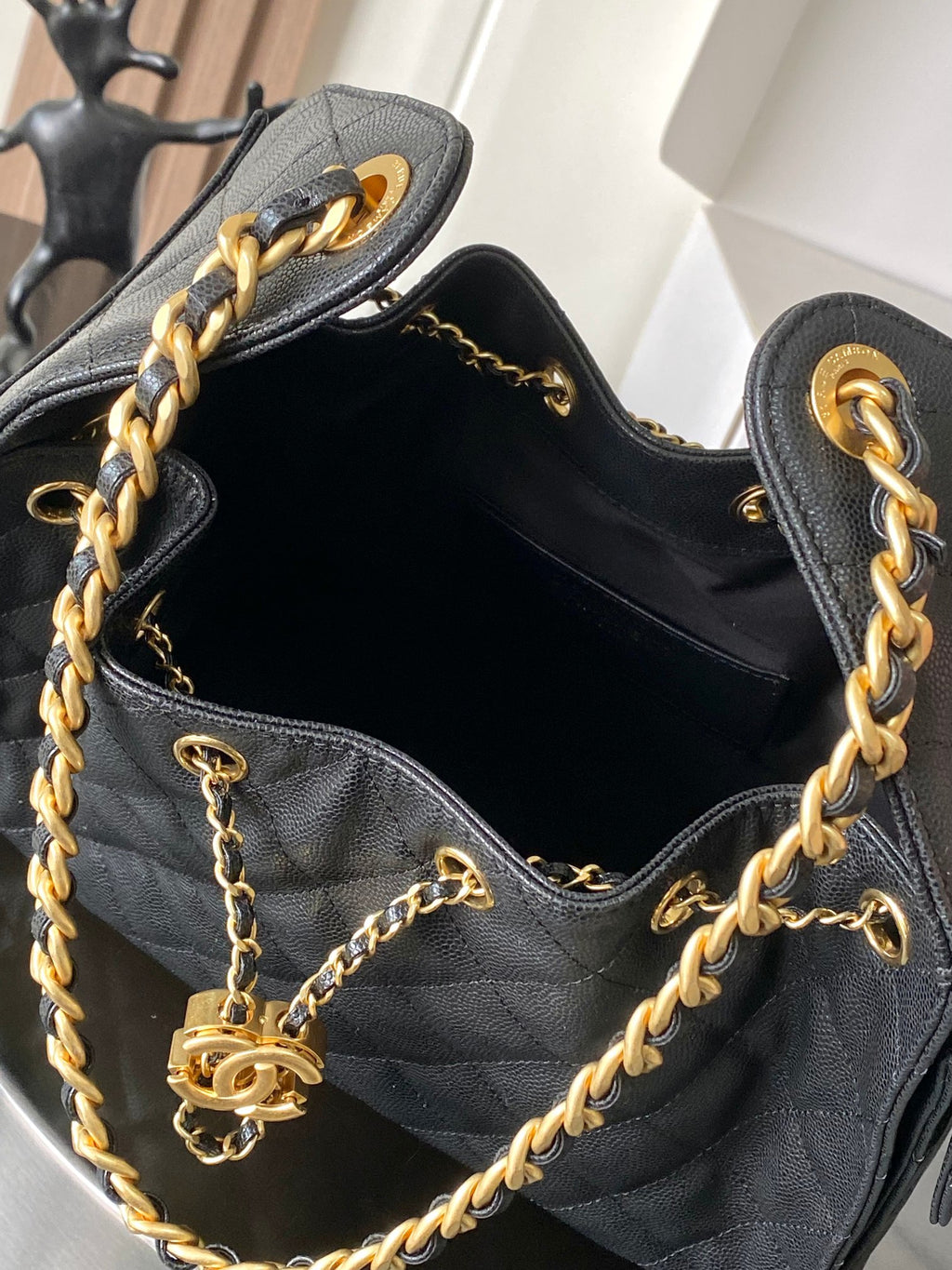 Chanel quilted leather hobo bag open view with gold chain strap and logo tag