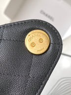 Chanel logo button hardware on dark gray textured leather flap