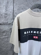Color-block T-shirt close-up with Balenciaga print and logo patch, cream and navy