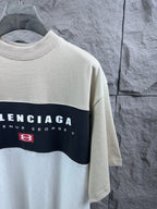 Color-block T-shirt close-up of Balenciaga chest print, cream with navy stripe