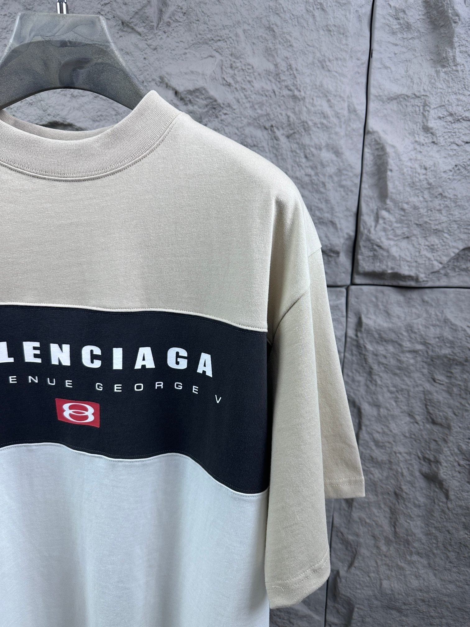 Color-block T-shirt close-up of Balenciaga chest print, cream with navy stripe