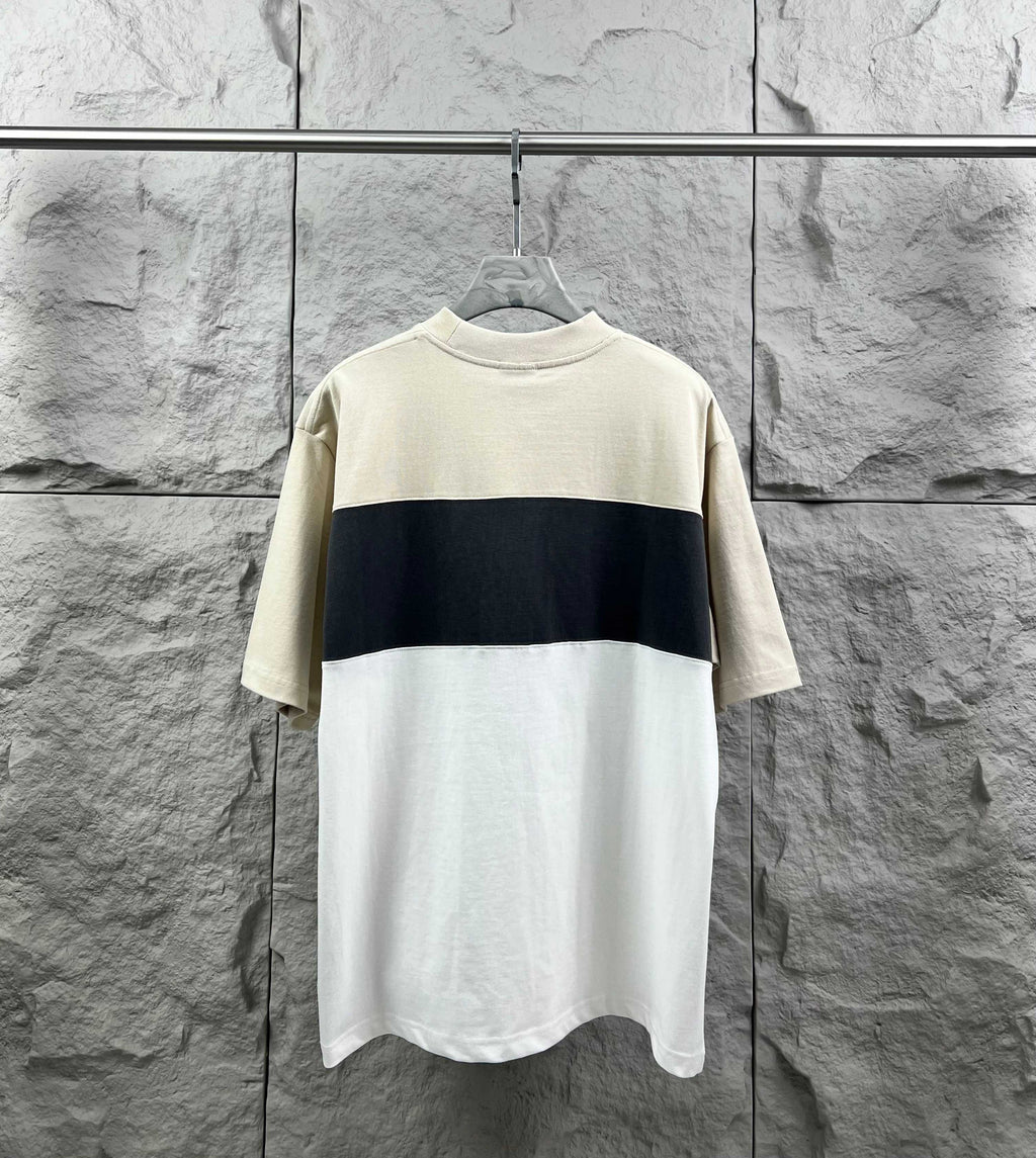 Color-block short-sleeve T-shirt with cream top and dark navy band, no visible logo