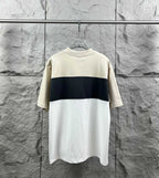 Color-block short-sleeve T-shirt with cream top and dark navy band, no visible logo