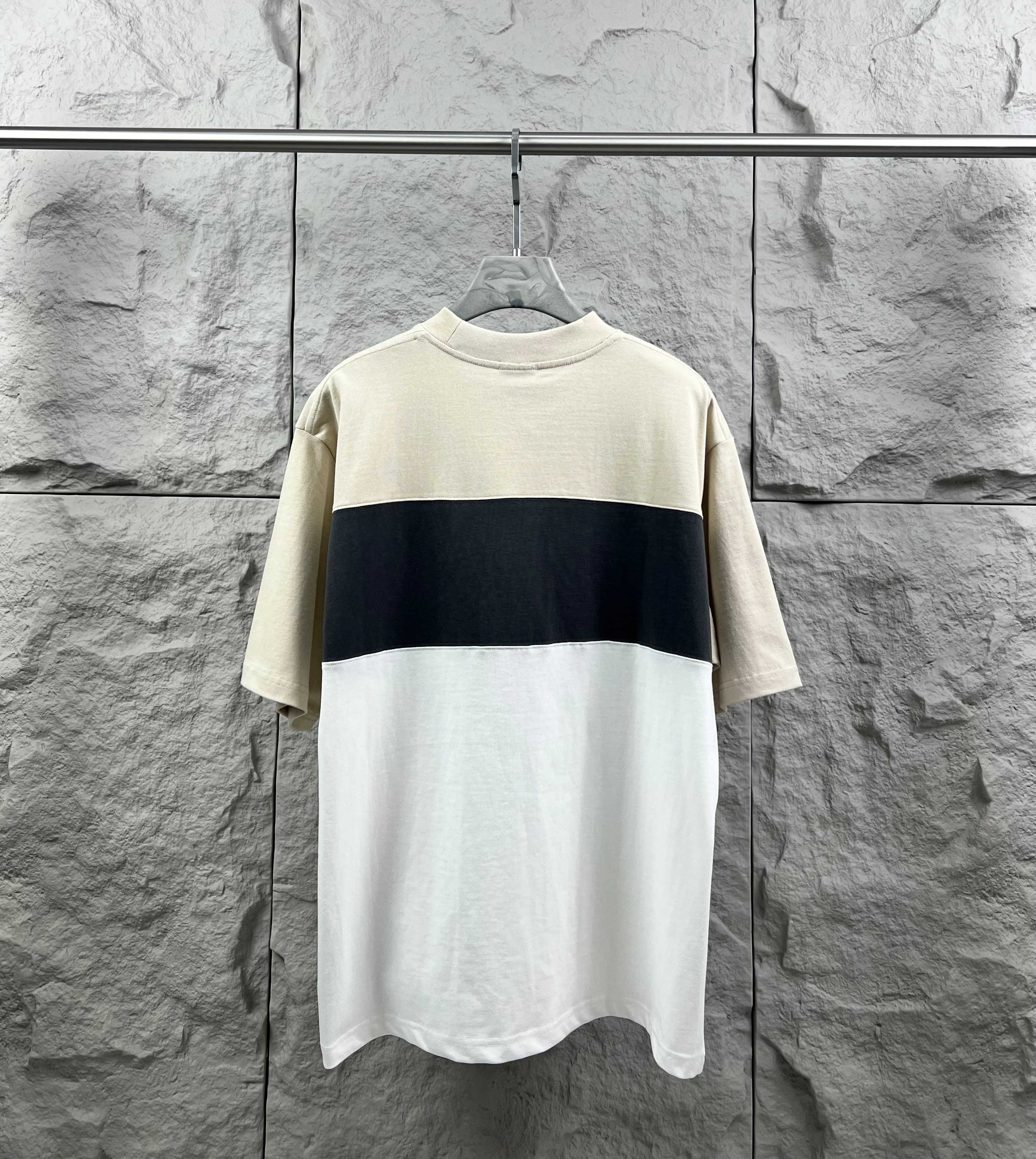 Color-block short-sleeve T-shirt with cream top and dark navy band, no visible logo