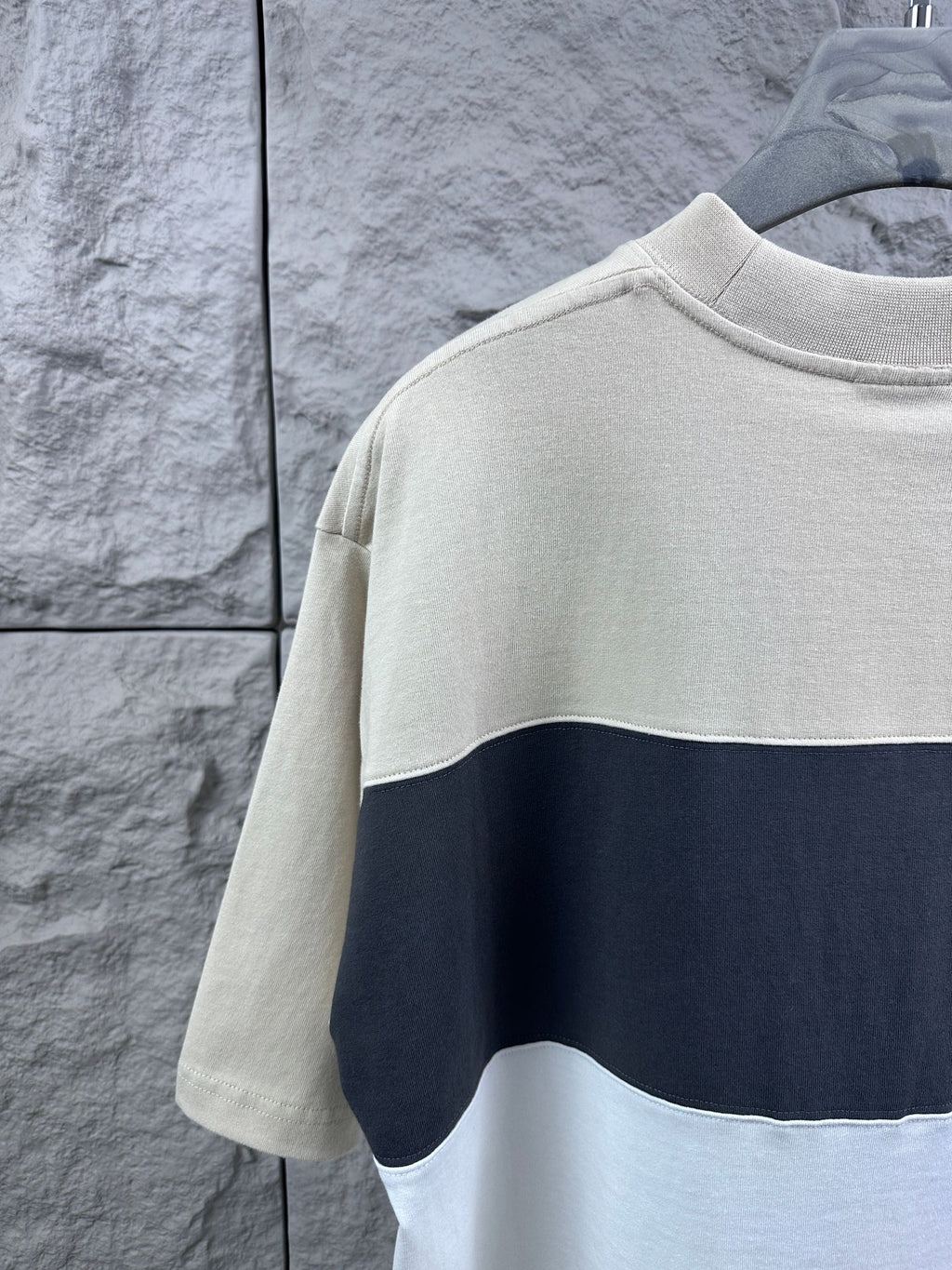 Back view color-block T-shirt, cream upper and navy band over white hem