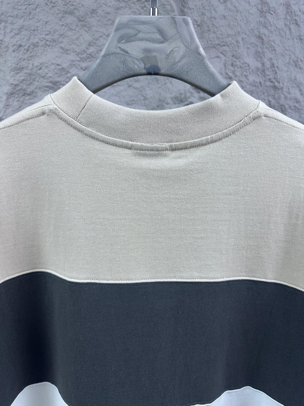 Crewneck T-shirt with color-block stripe, cream upper and navy band, no visible logo