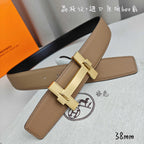 Belt with tan leather strap and gold buckle detail, angled close-up