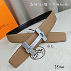 Belt with tan leather strap and silver buckle detail, angled close-up