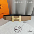 Belt with tan leather strap and gold square buckle, dual prongs, front view