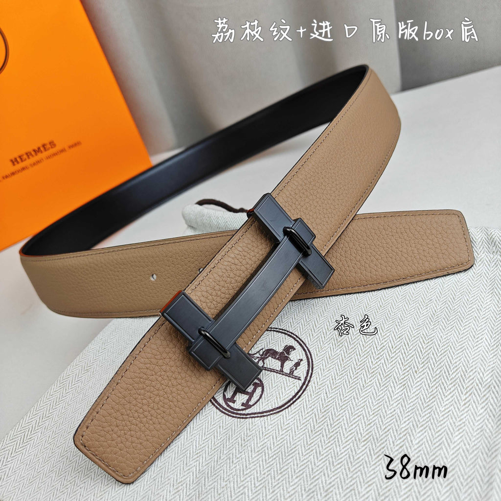Belt with tan leather strap and dark gray buckle detail, angled close-up