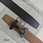 Belt with tan leather strap and black keeper, dark buckle, top view