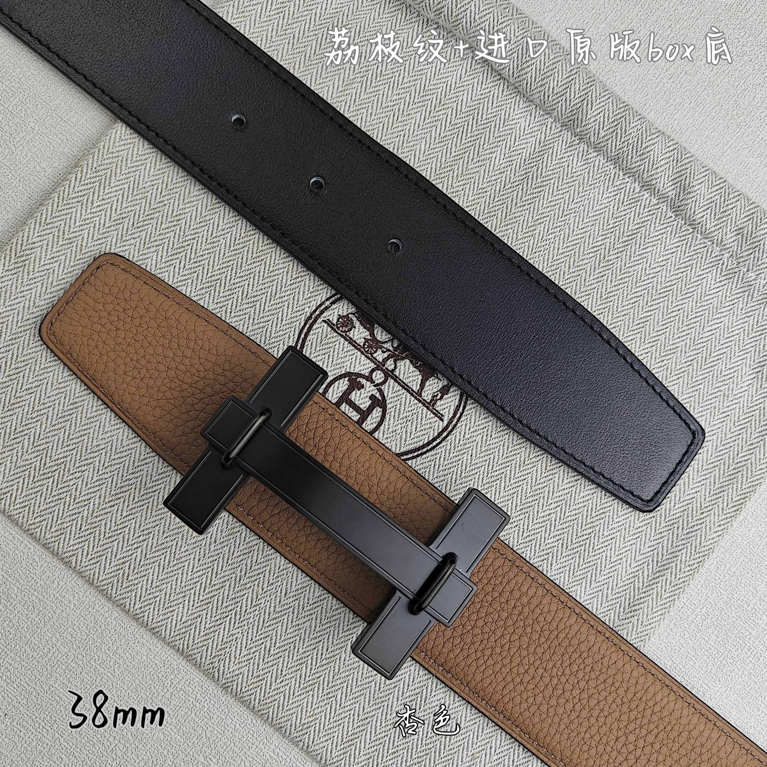 Belt with tan leather strap and black keeper, dark buckle, top view