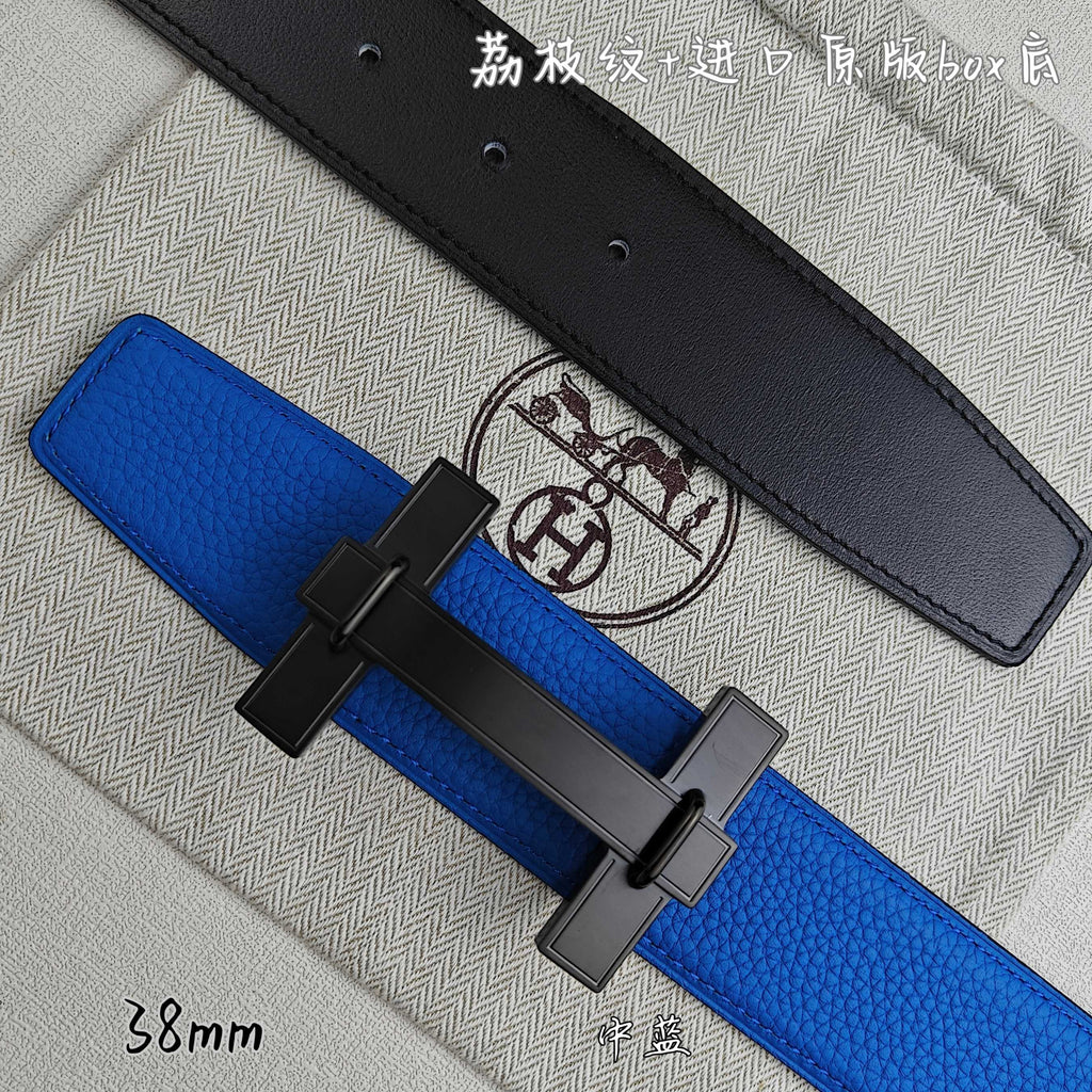Blue Hermes belt with black buckle over; black belt lies behind.