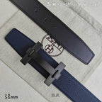 Blue and black leather belts with dark-tone H buckle, close-up side view.
