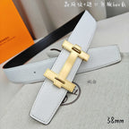 White leather belt with gold-tone buckle and long strap keeper.