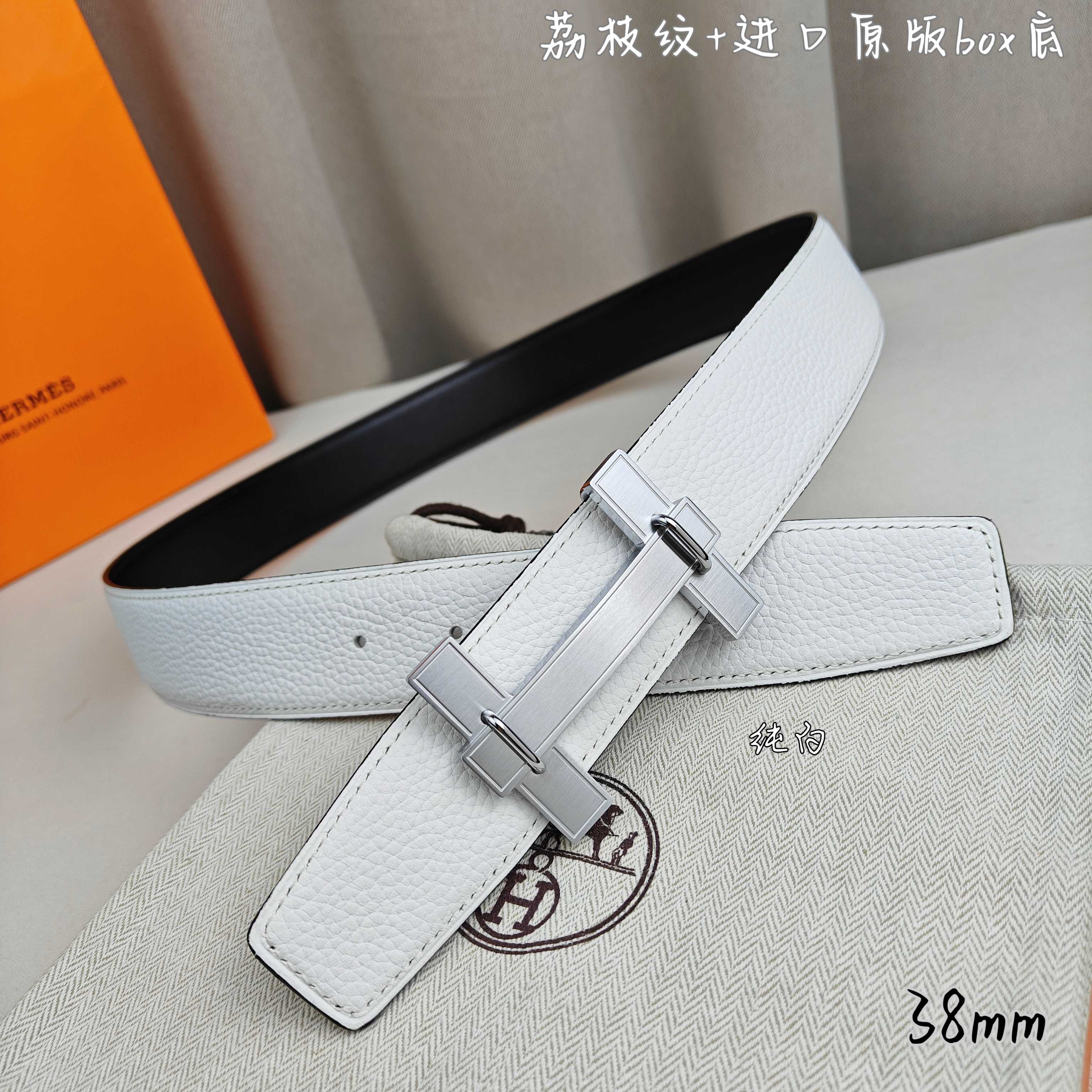White leather belt with silver-tone buckle and long strap keeper.