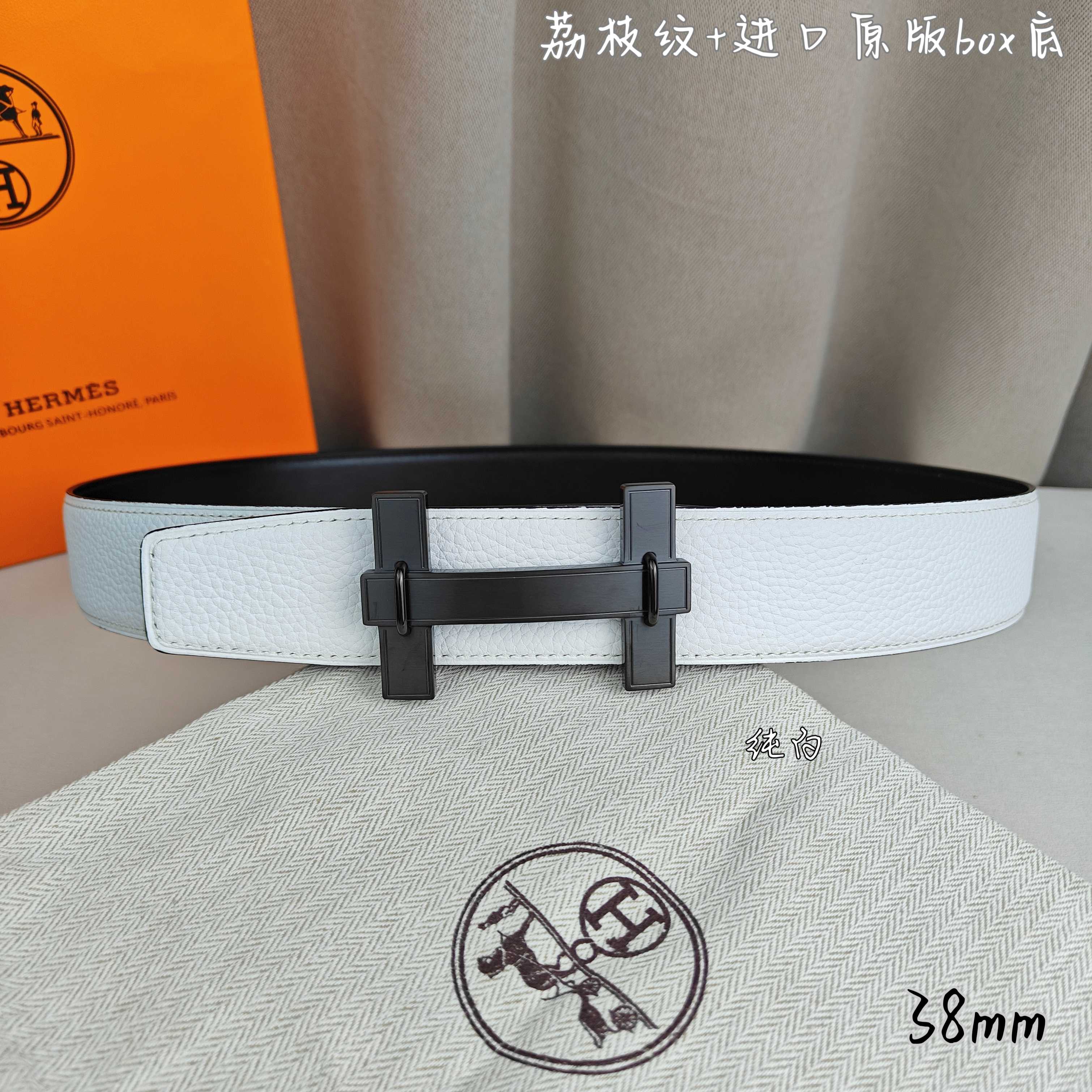 White leather belt with dark charcoal rectangular buckle and double-bar frame.