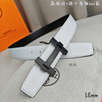 White leather belt with dark charcoal buckle and long strap keeper.