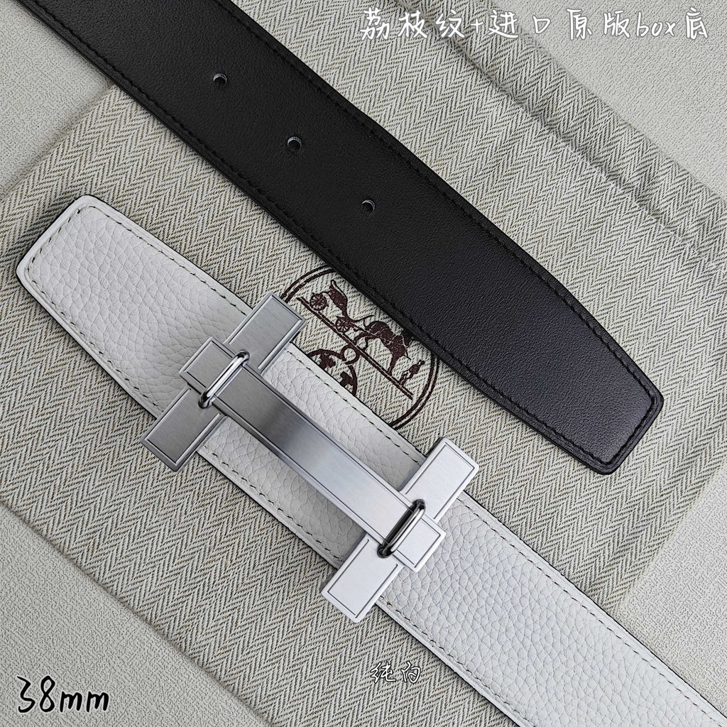 White leather belt with black keeper strap and silver-tone rectangular buckle.