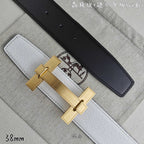 White leather belt with black keeper strap and gold-tone rectangular buckle.
