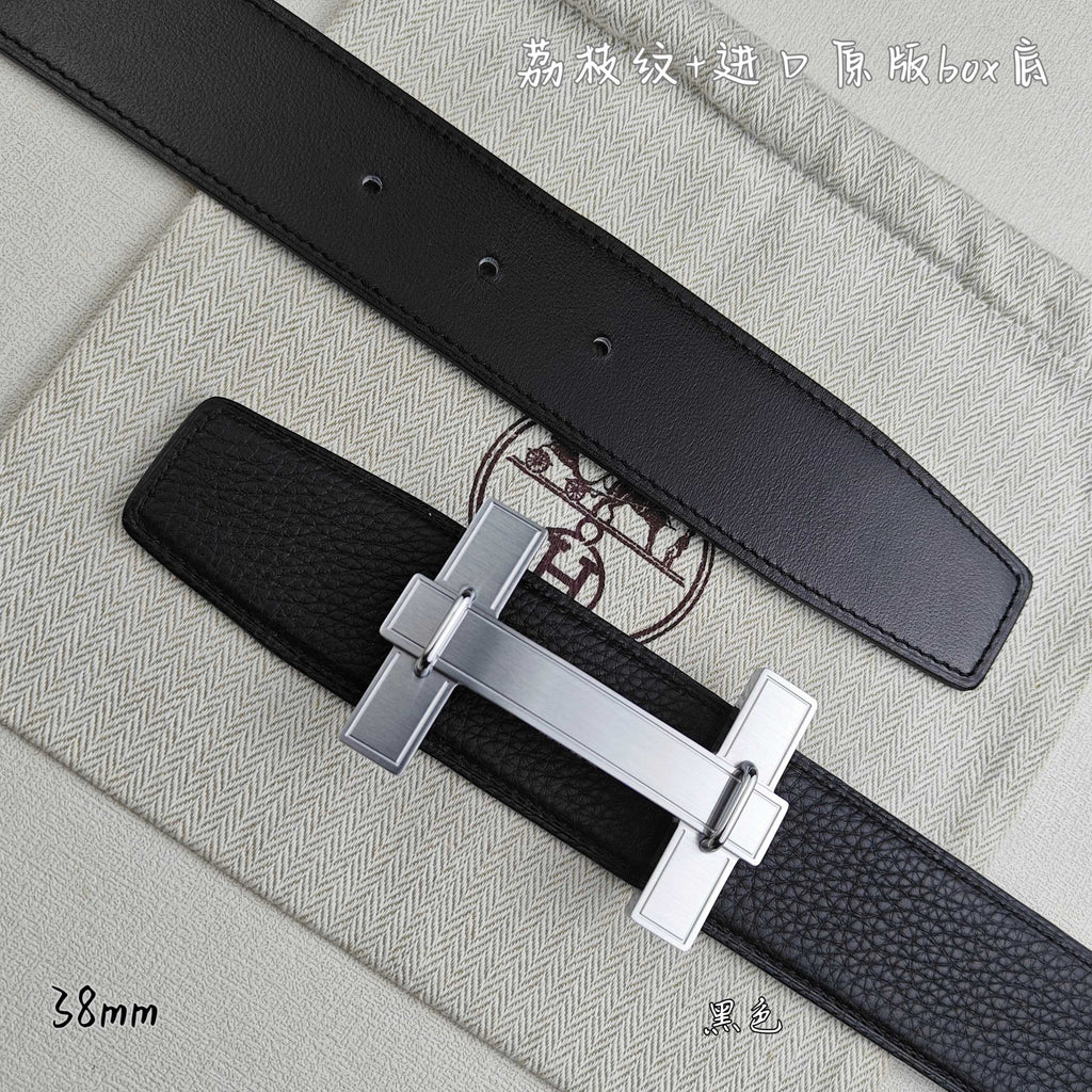 Leather belt detail: silver-tone H buckle on dark strap
