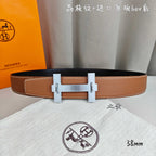 Hermes belt in tan leather with silver-tone buckle and double keeper straps.