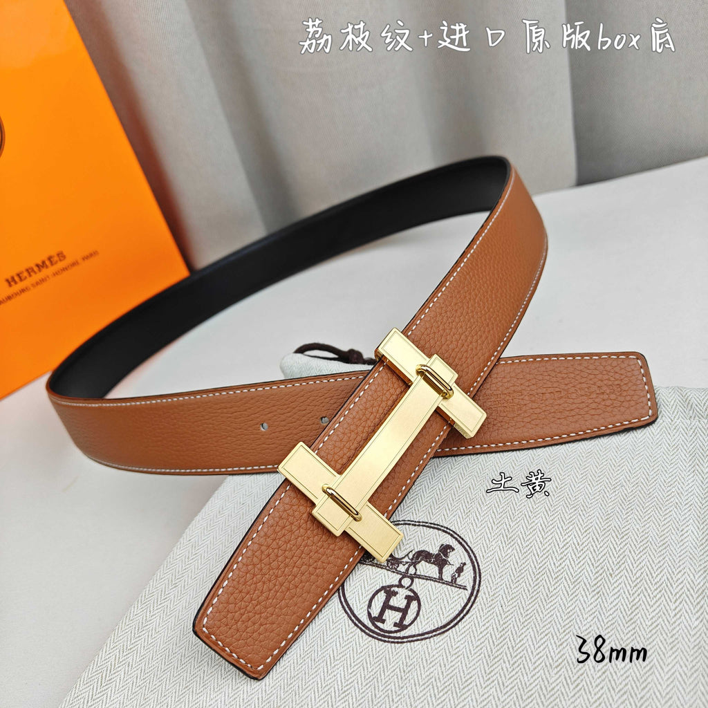 Hermes belt in tan leather with gold-tone buckle and crossbar keeper strap.