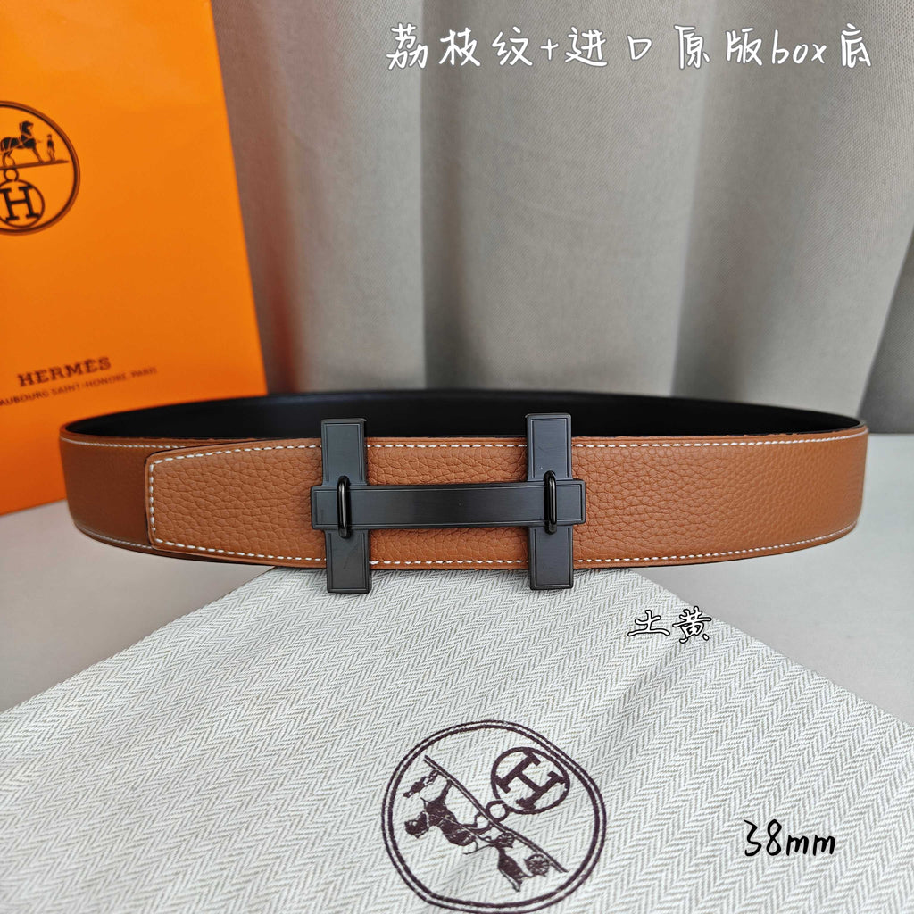 Hermes belt in tan leather with dark-tone buckle and double keeper straps.