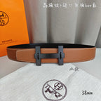 Hermes belt in tan leather with dark-tone buckle and double keeper straps.