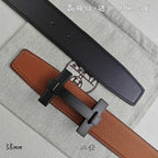 Hermes belt with tan leather and black underside, dark-tone buckle detail.
