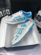 White and blue lace-up sneakers with speckled uppers and bold blue overlays