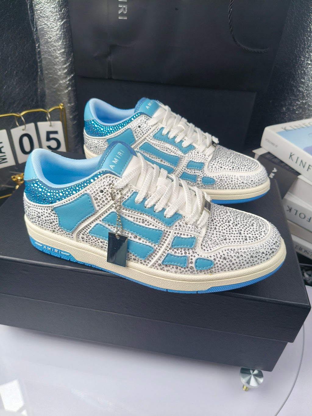 Blue and white low-top sneakers with rhinestone trim and lace-up front