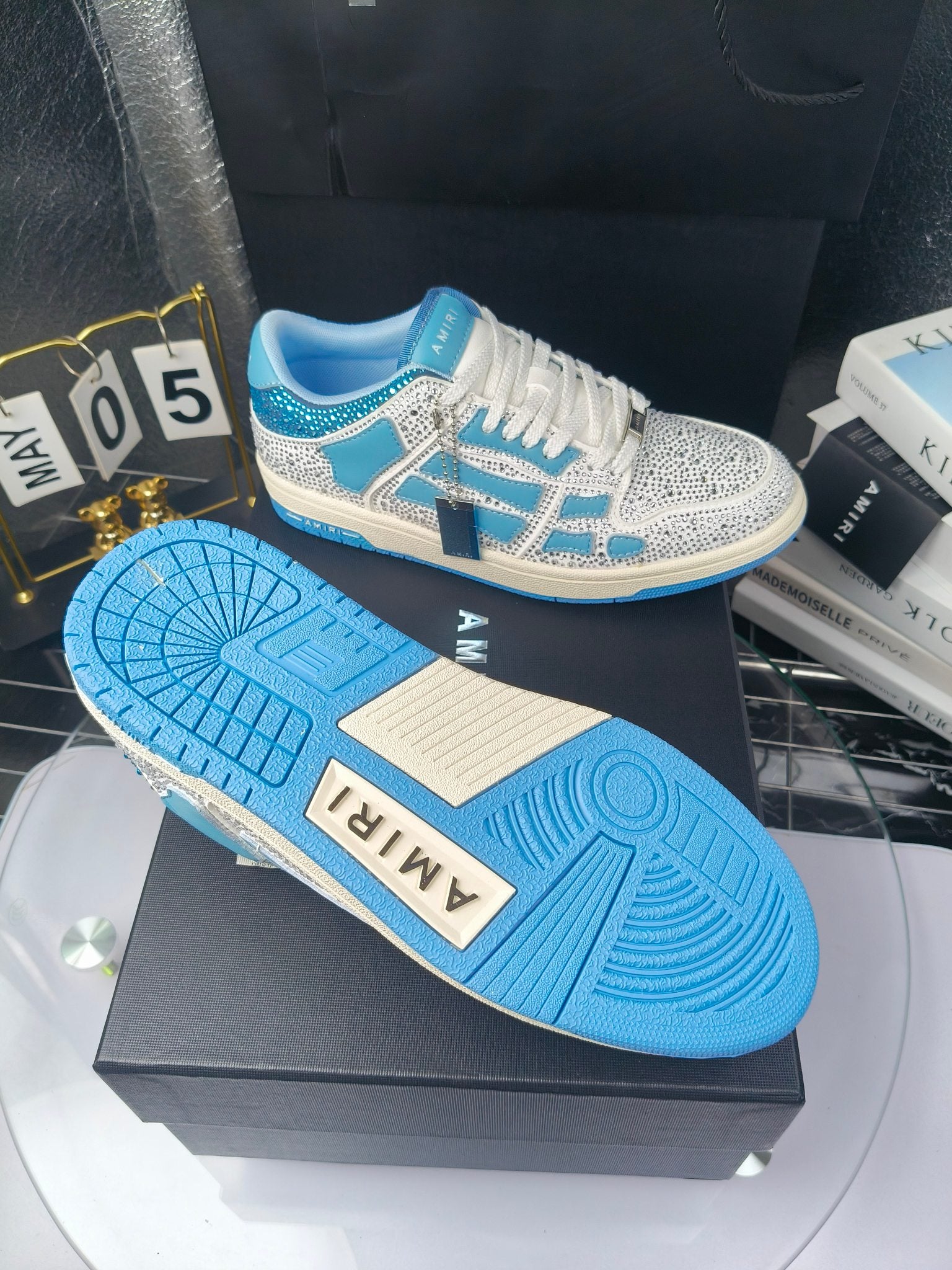 Blue and white sneaker outsole and side view on a shoe box