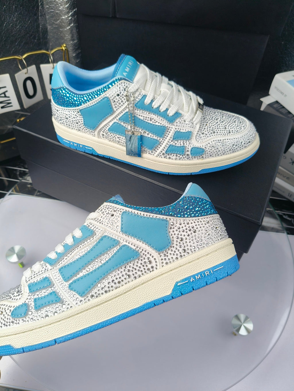 Side view of white and blue lace-up sneakers with speckled texture and trim