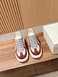 Alexander McQueen sneakers pair, white base with burgundy panels and grey lace-up uppers
