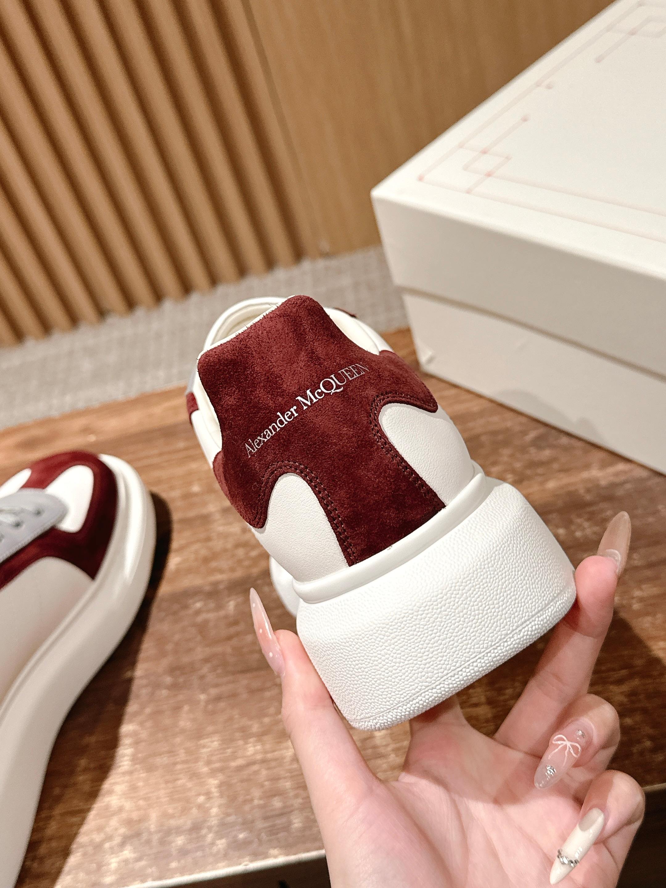 Alexander McQueen sneakers heel view with logo text on burgundy suede and white sole