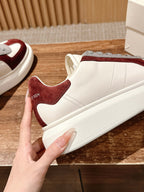 Alexander McQueen low-top sneakers side profile, white leather with burgundy suede trim