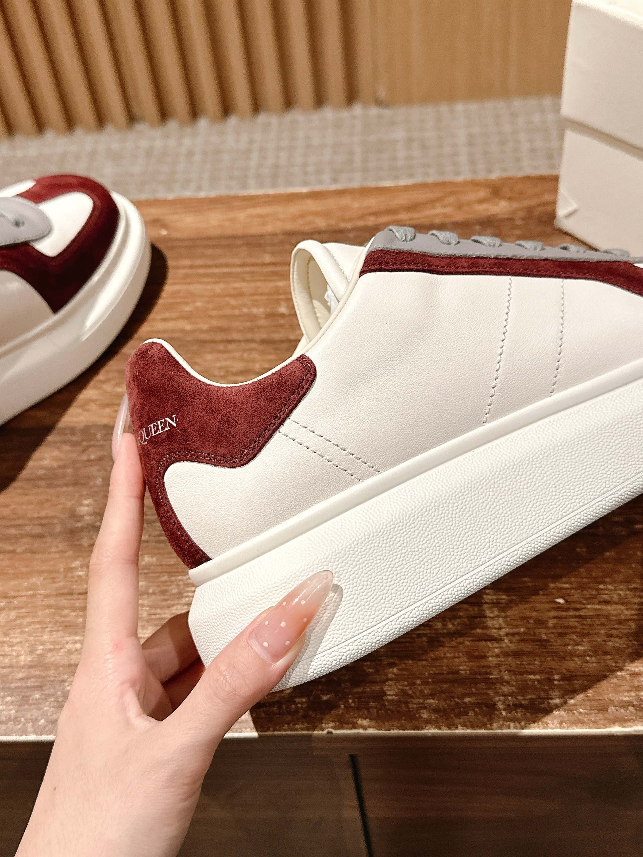 Alexander McQueen low-top sneakers side profile, white leather with burgundy suede trim