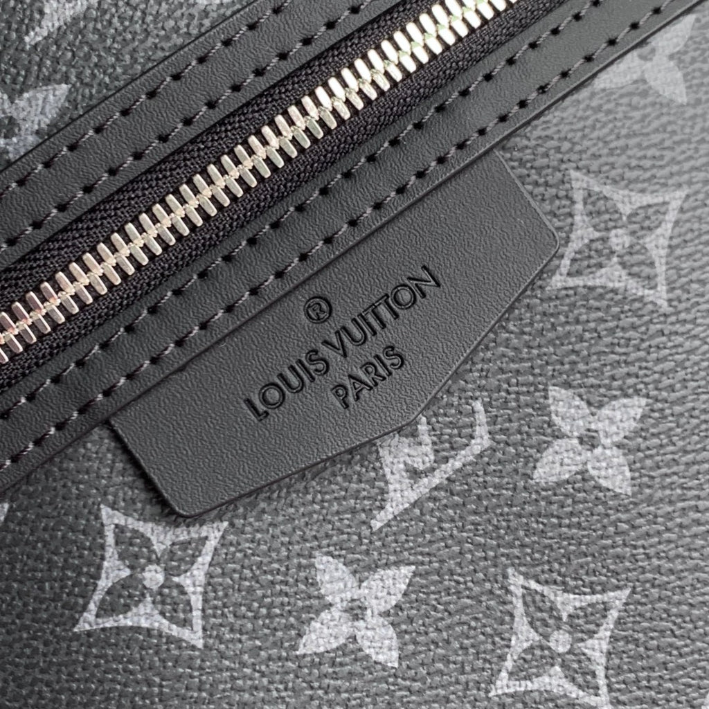 Louis Vuitton leather logo label on monogram canvas with silver zipper teeth