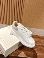 Alexander McQueen white leather sneakers with gray suede overlay and lace-up front