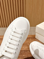Alexander McQueen white lace-up sneakers with textured side paneling