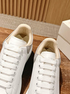 Alexander McQueen sneakers side view with white laces and cream-lined interior