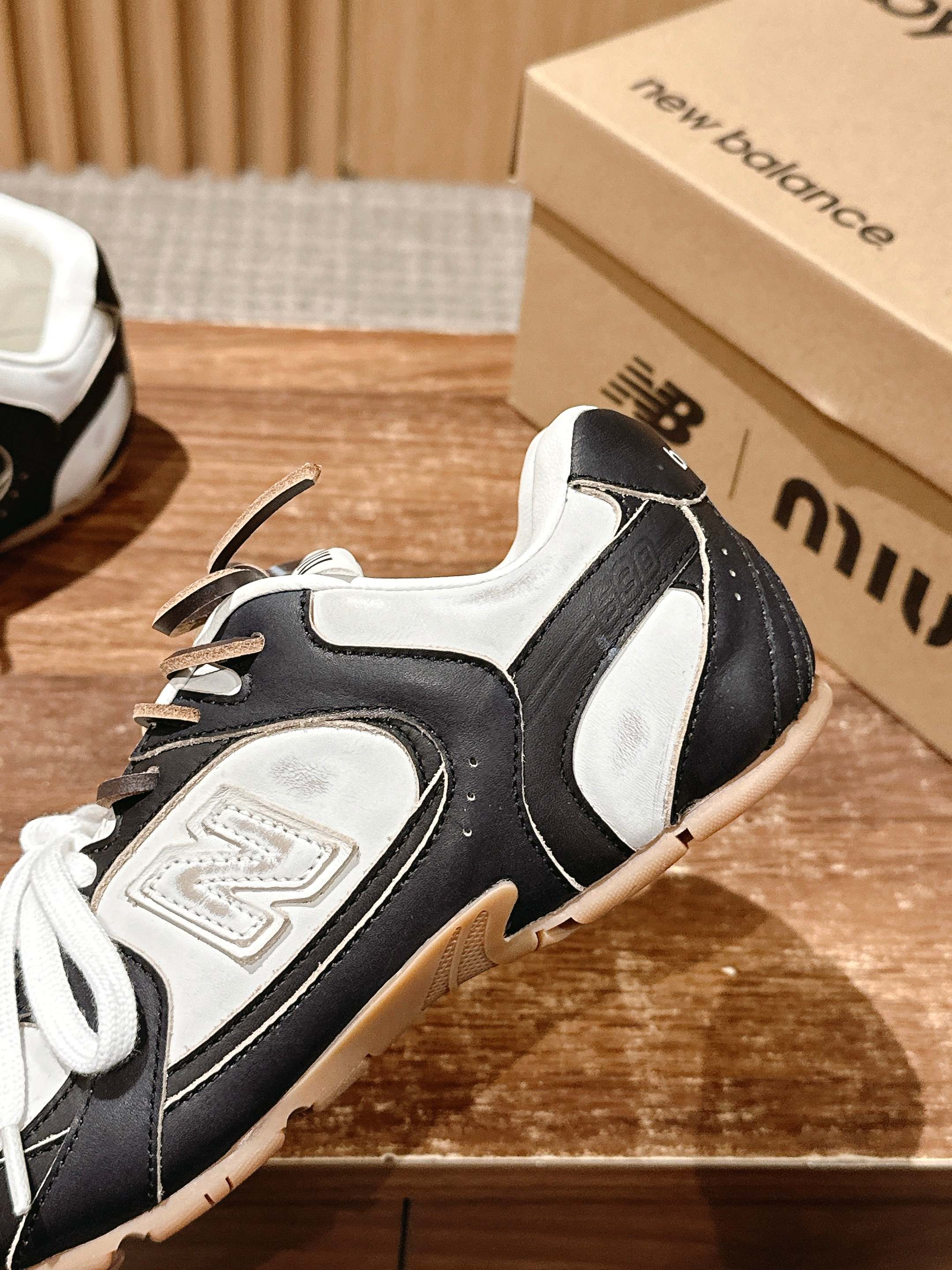 Black and white unisex sneaker side view with white laces and textured sole