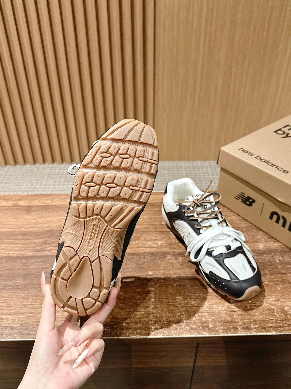Unisex sneaker showing outsole tread with black-and-white upper